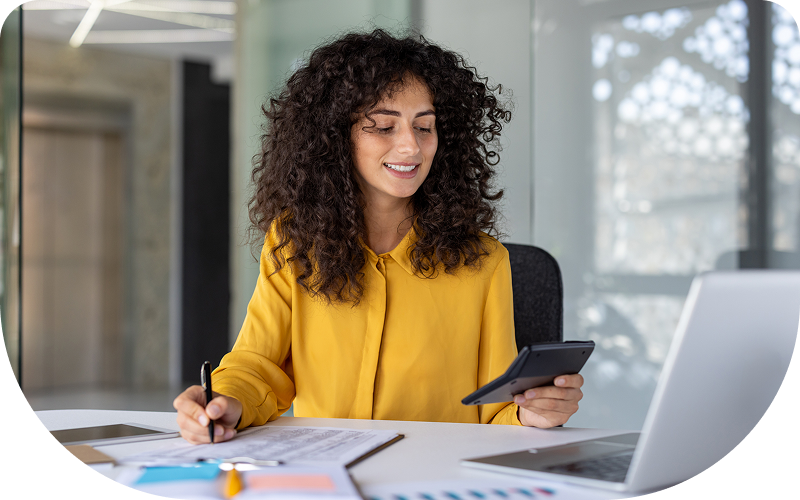 Woman working at desk with tablet.